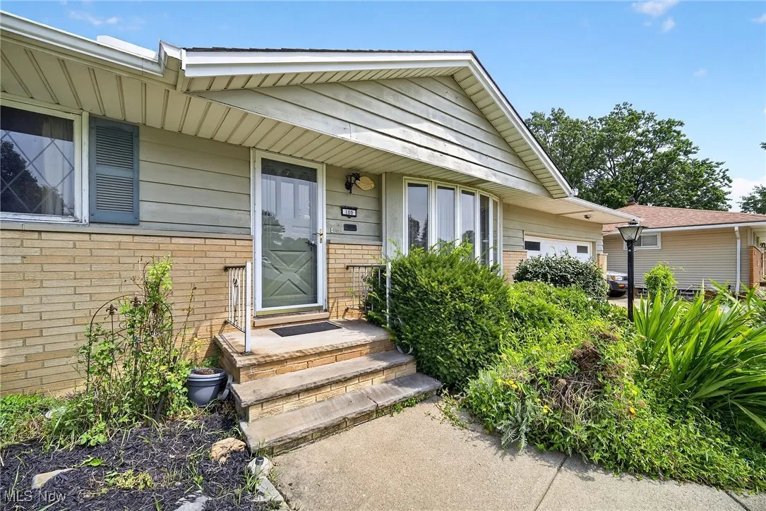Property entrance featuring brick siding