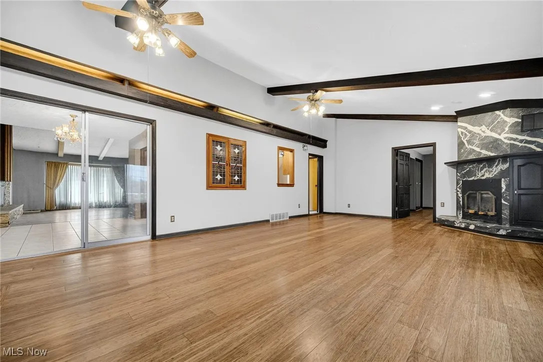Great Room with cathedral ceilings, bamboo wood finished floors and a high end marble fireplace that has a 65% high efficiency  wood burning insert.