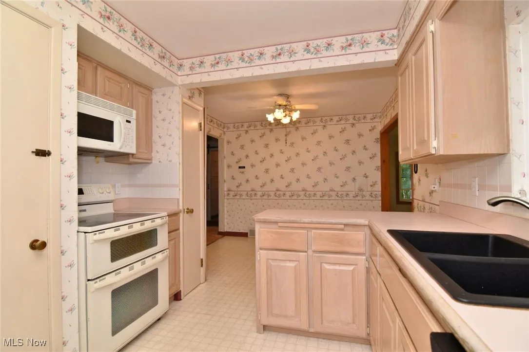 Kitchen with light cabinets and peninsula