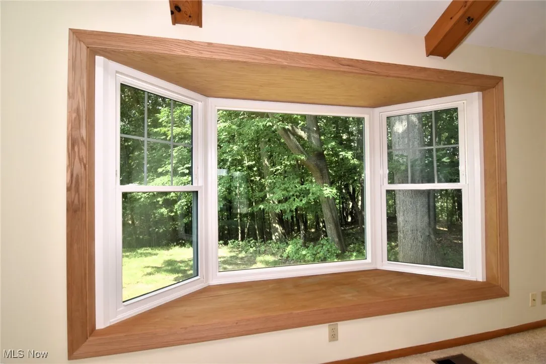 Large bay window in family room with a view of the wooded ravine