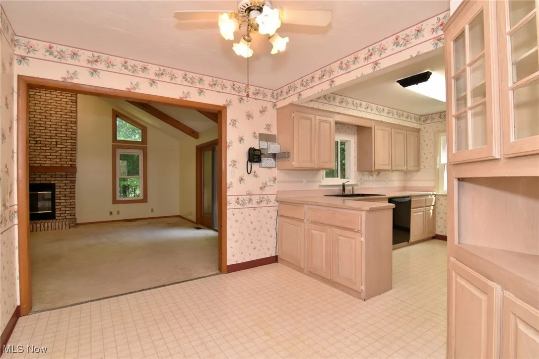 Kitchen with glass insert cabinets and dining area