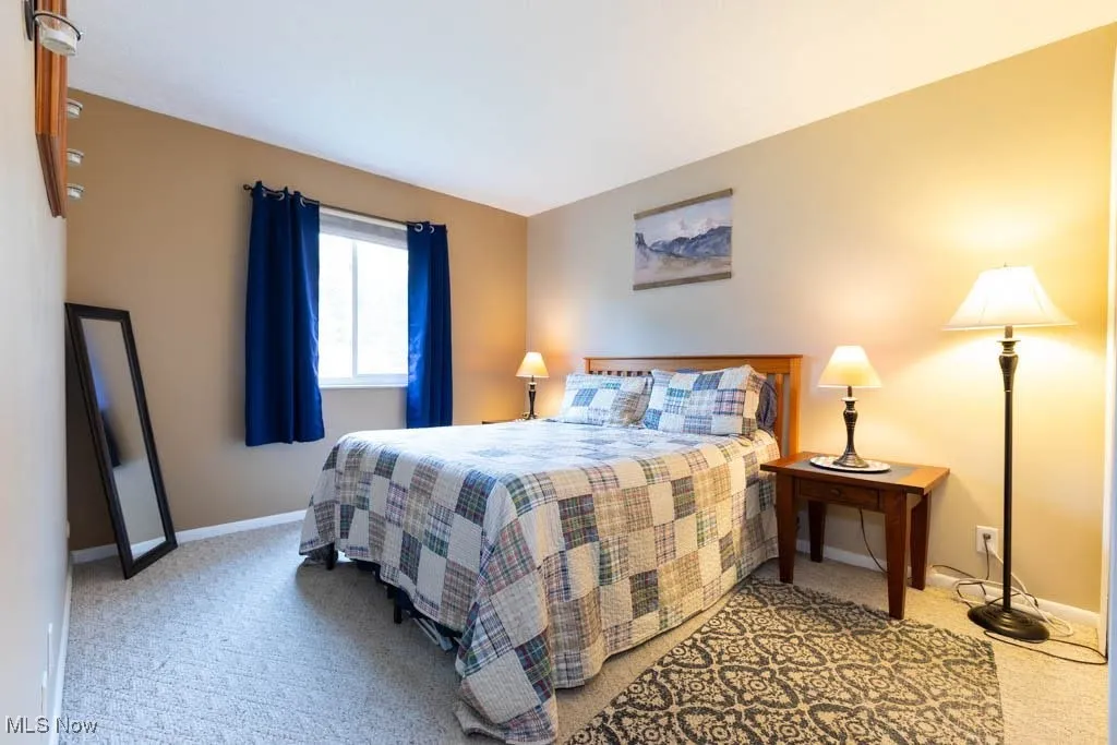Carpeted bedroom featuring baseboards