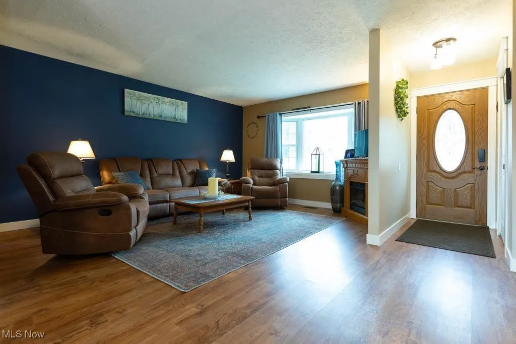Living area featuring wood finished floors and a textured ceiling