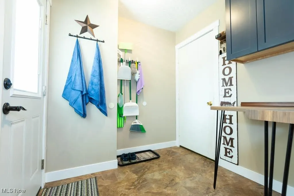 Doorway featuring baseboards