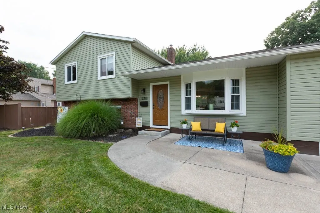 Split level home with a chimney and brick siding