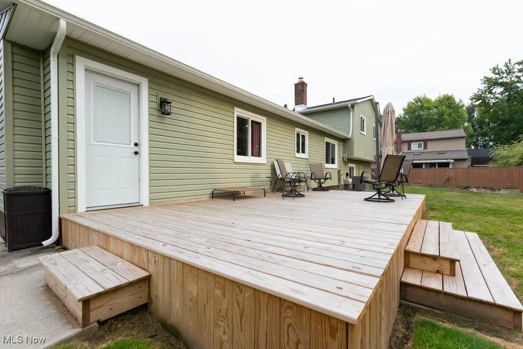 Wooden deck featuring outdoor dining area