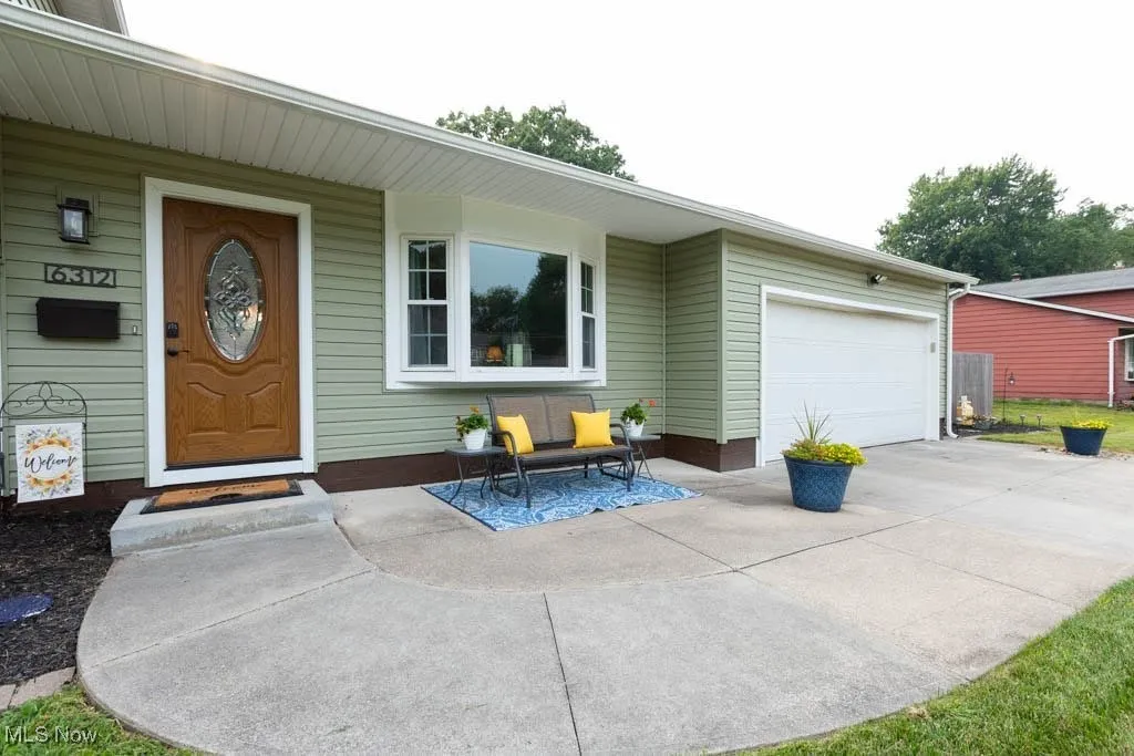Property entrance with a garage and driveway