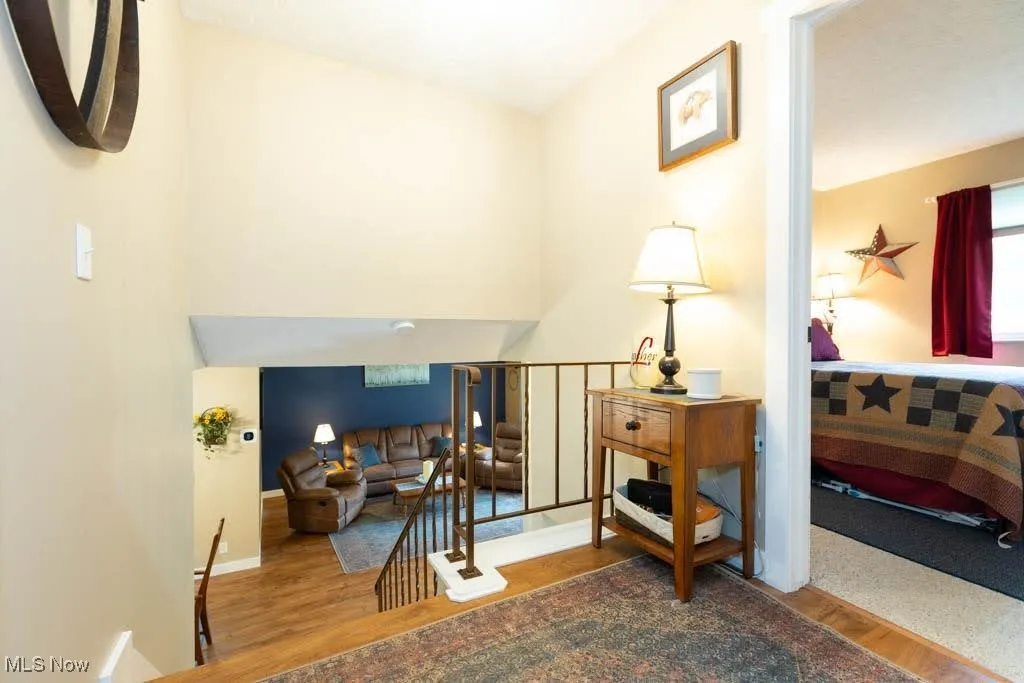 Sitting room featuring wood finished floors and an upstairs landing