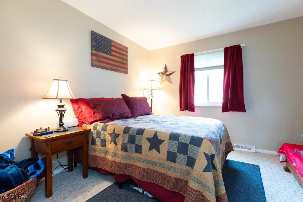 Carpeted bedroom with baseboards