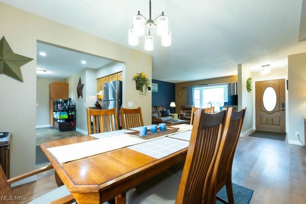 Dining space featuring a chandelier and light wood-type flooring