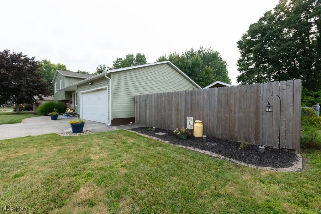 View of property exterior with driveway and a garage