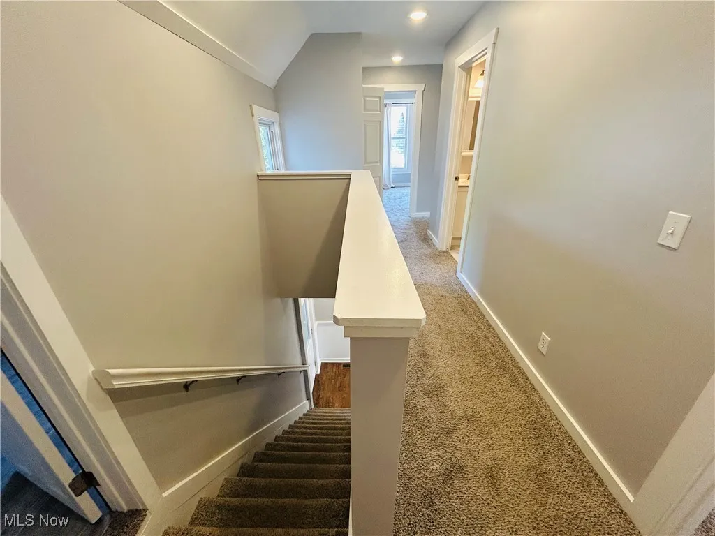Staircase with carpet, vaulted ceiling, and recessed lighting
