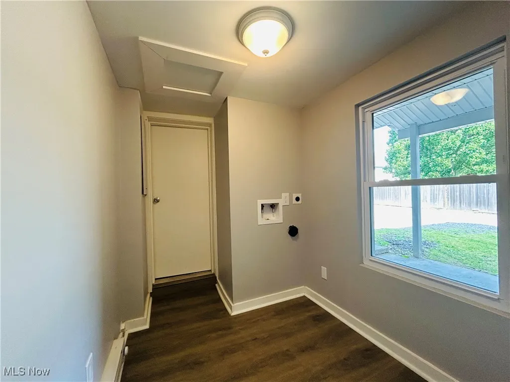 Washroom featuring hookup for an electric dryer, attic access, dark wood finished floors, and hookup for a washing machine 1st floor laundry