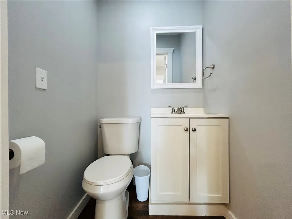 Bathroom featuring vanity and wood finished floors 1/2 bath main floor