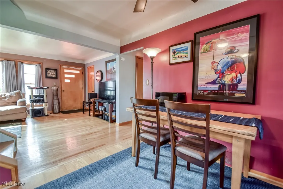 Dining space with wood finished floors and a ceiling fan