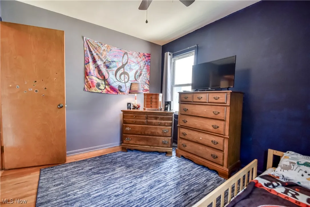 Bedroom with wood finished floors and ceiling fan