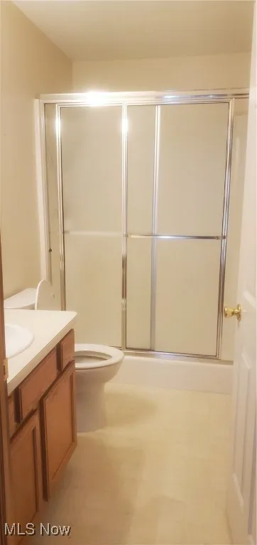 Bathroom featuring vanity, an enclosed shower, and tile patterned floors