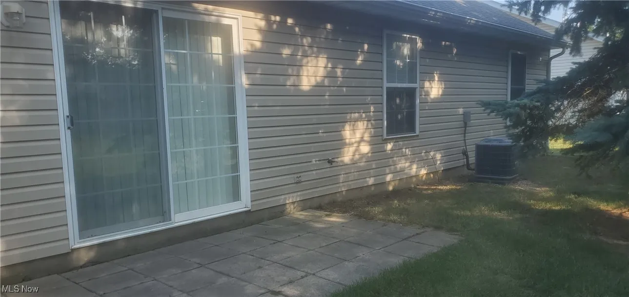 View of back of property featuring a patio
