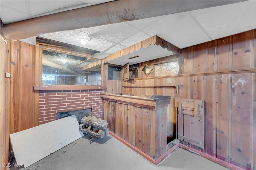 Below grade area featuring wooden walls and a fireplace