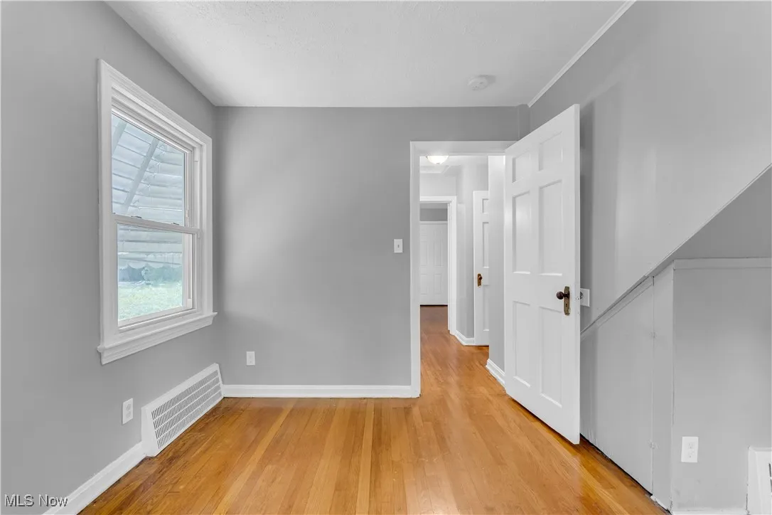 Spare room with light wood-type flooring and a textured ceiling