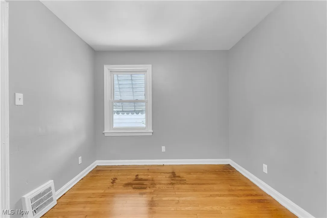Empty room featuring light wood finished floors and baseboards