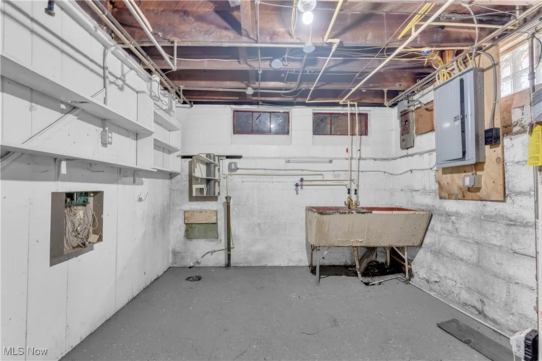 Unfinished basement with electric panel