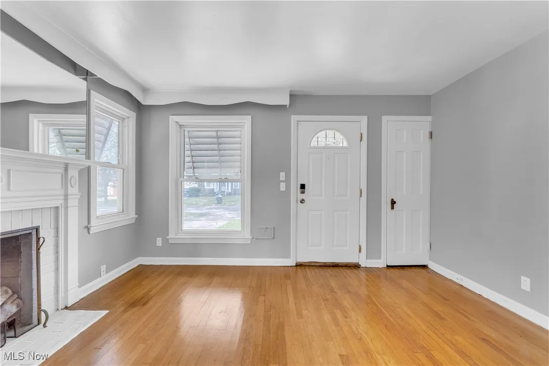 Foyer with healthy amount of natural light, a fireplace, and light wood finished floors