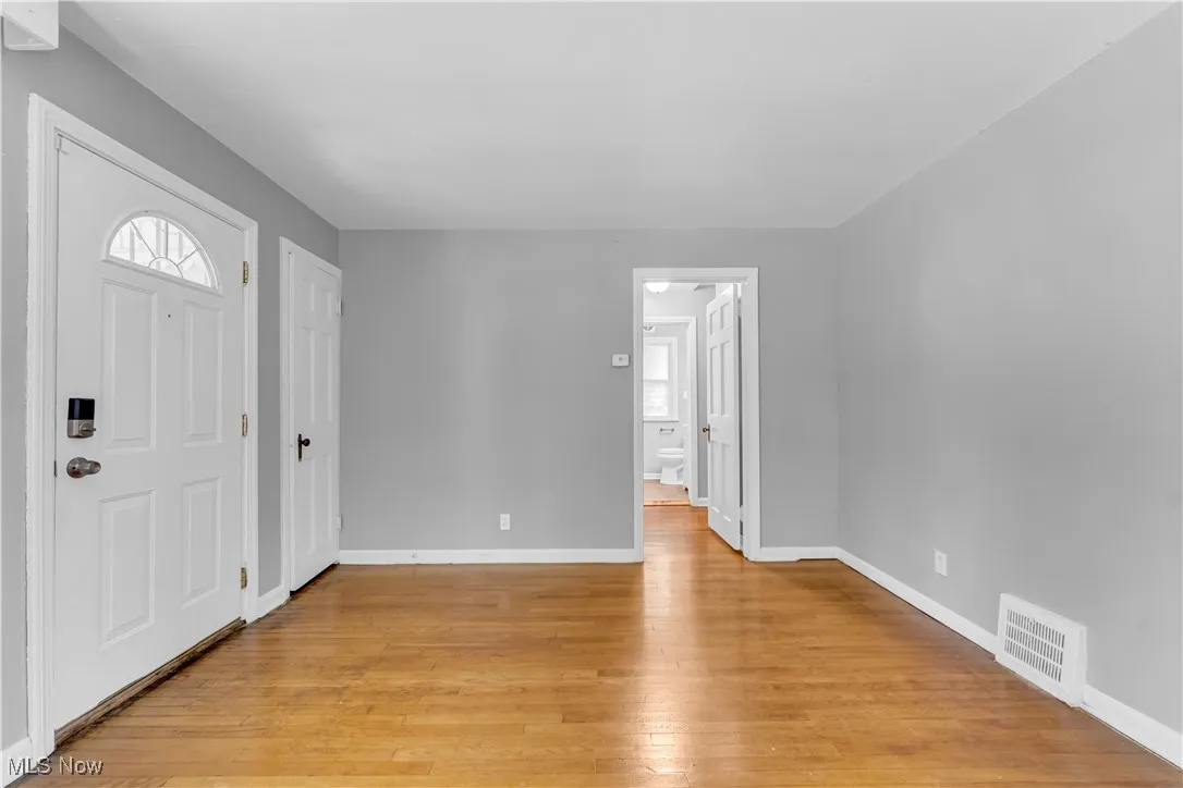 Entrance foyer featuring light wood-type flooring and baseboards