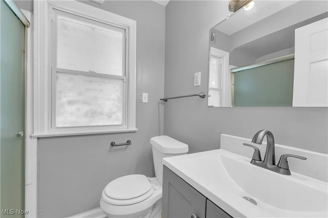 Bathroom with vanity and a shower with shower door
