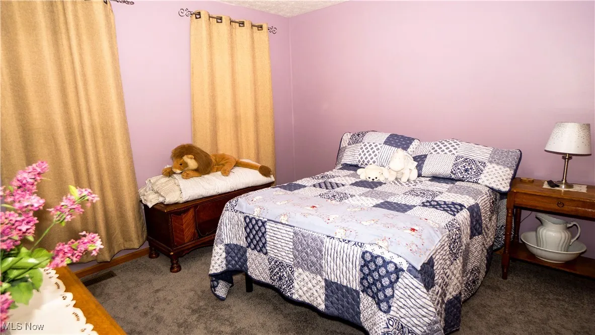 Carpeted bedroom with a textured ceiling