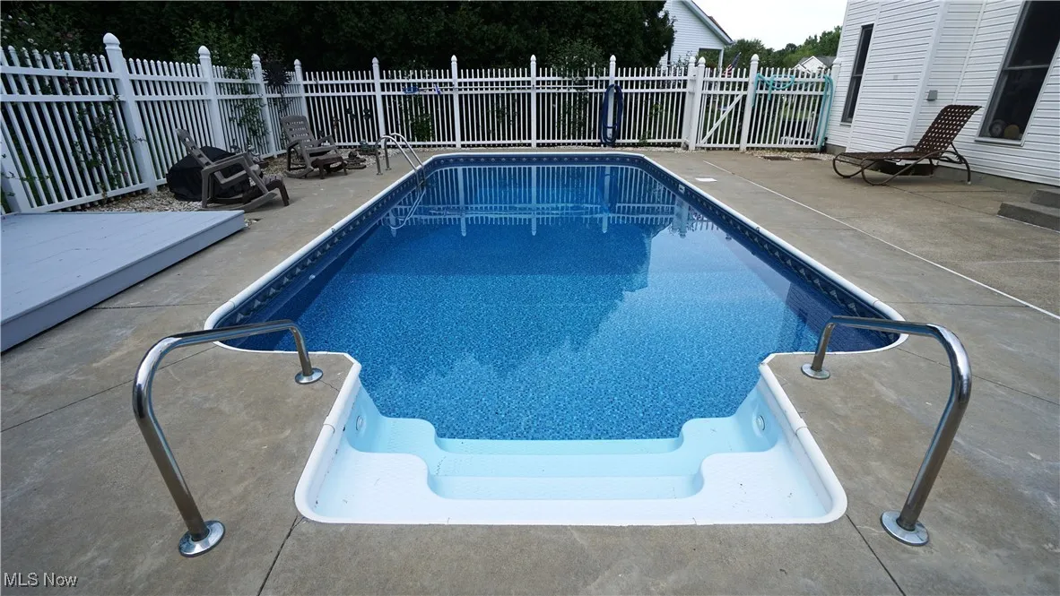 View of swimming pool with a patio