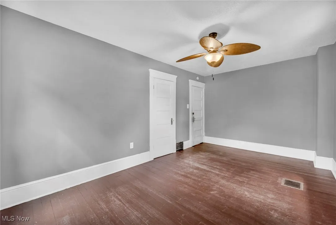 Unfurnished room featuring wood finished floors and a ceiling fan