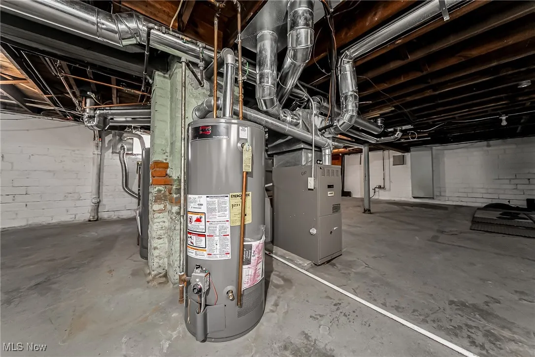 Unfinished below grade area with water heater and heating unit