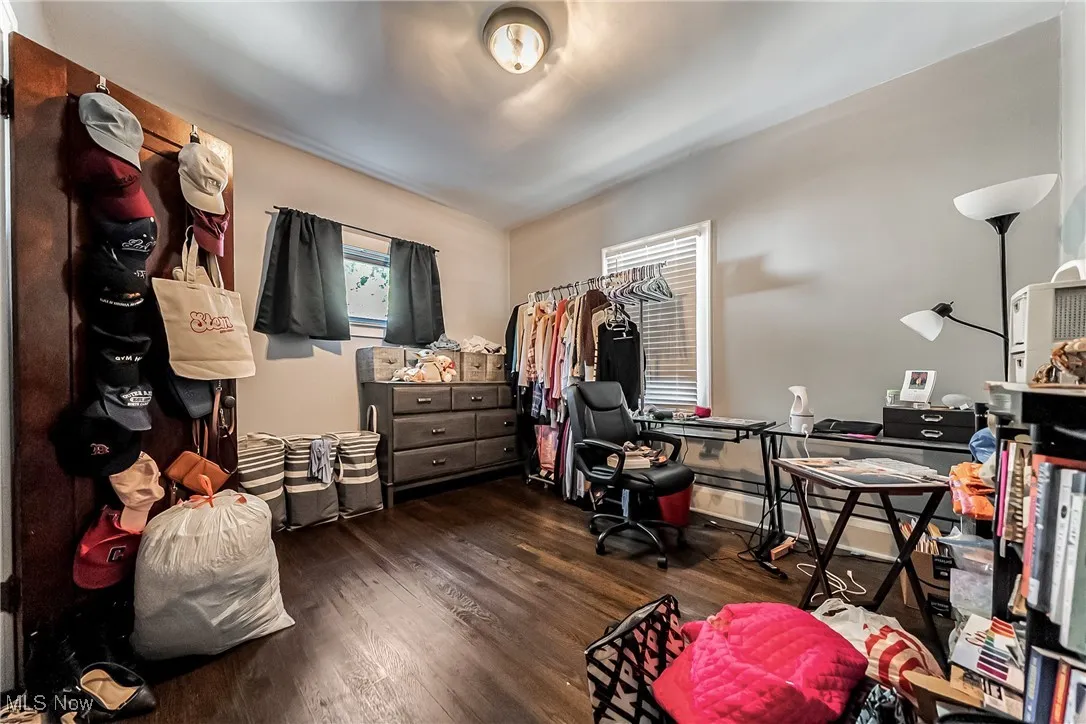 Bedroom featuring wood finished floors and baseboards