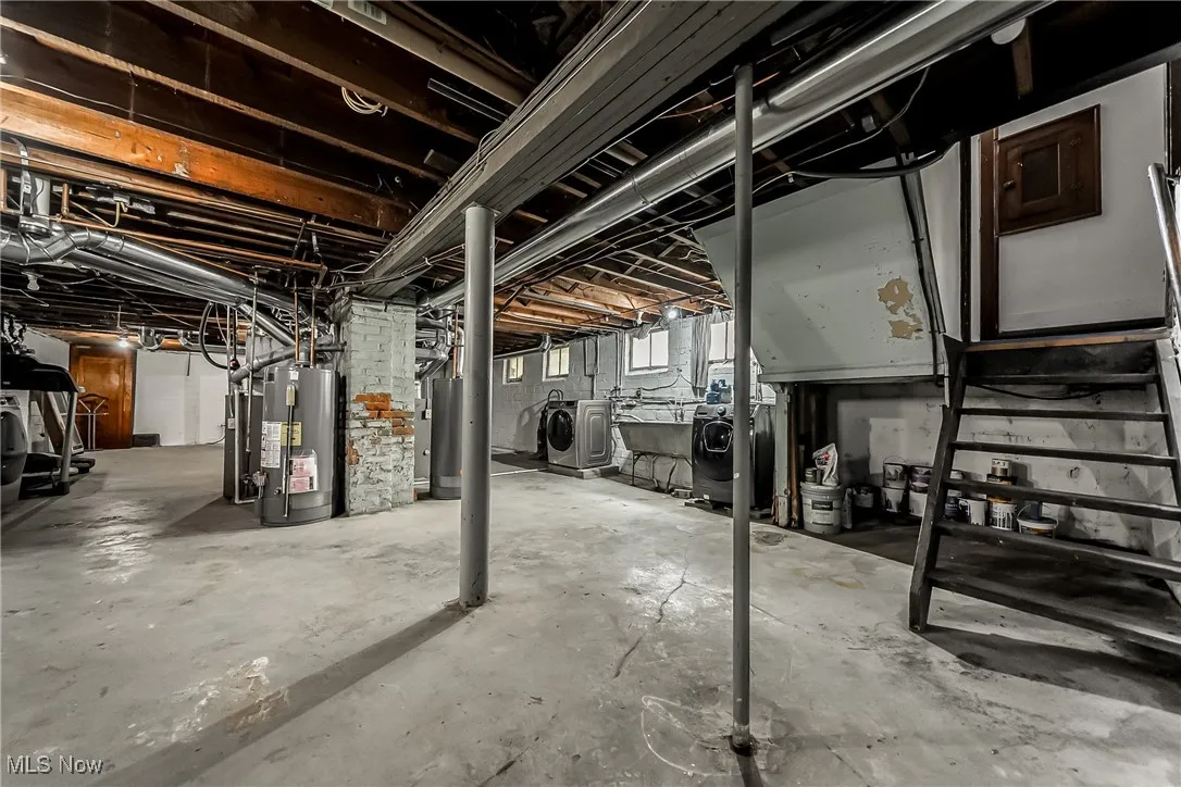 Below grade area featuring washer and dryer and gas water heater