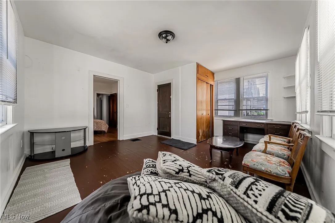 Bedroom with wood finished floors and a closet