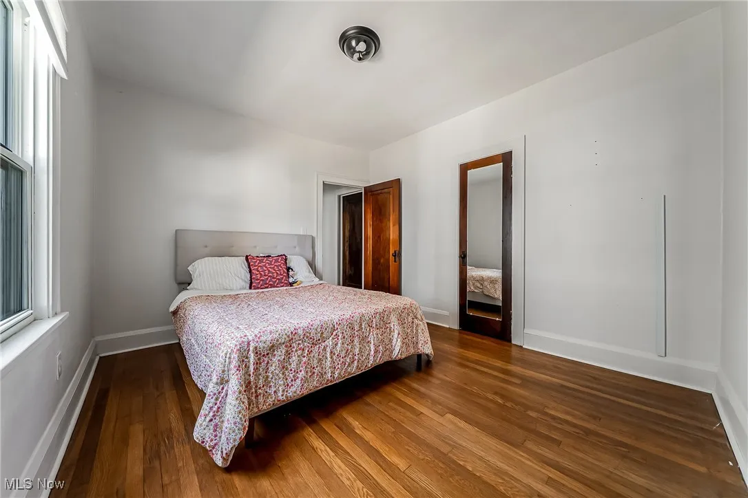 Bedroom featuring wood finished floors and baseboards