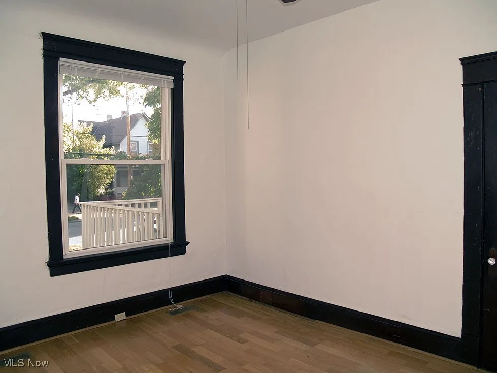 Spare room with wood finished floors and baseboards