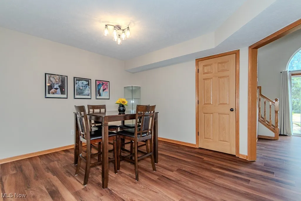 Dining space featuring stairs and wood finished floors