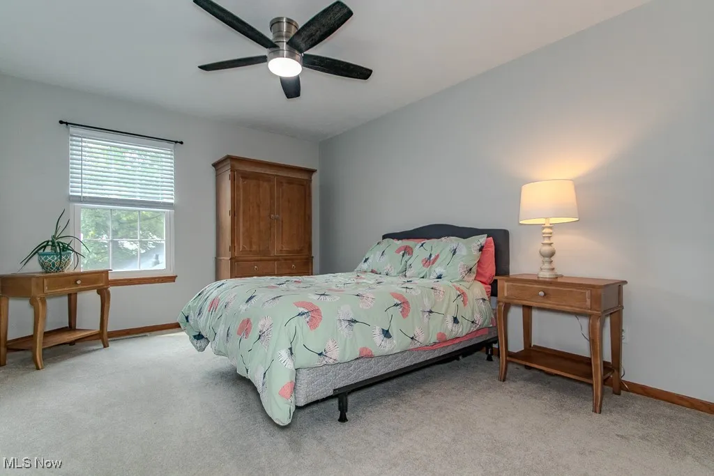 Bedroom featuring light carpet and a ceiling fan