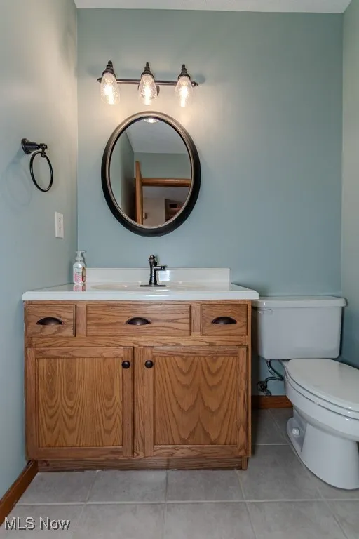 Bathroom with tile patterned floors and vanity