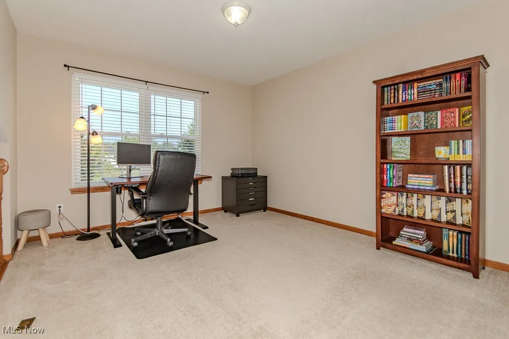 Carpeted office featuring baseboards