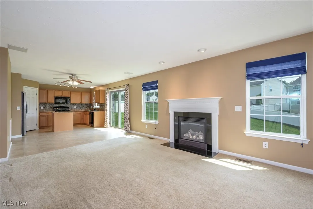 Living room with light carpet and a fireplace