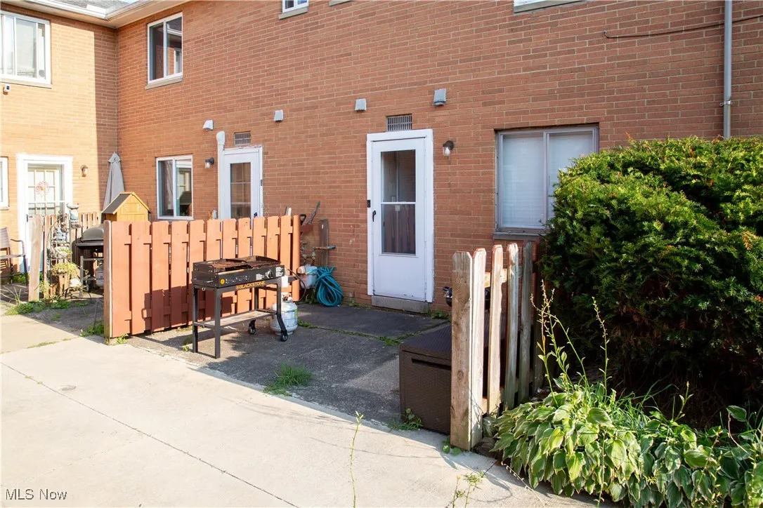 View of exterior entry with brick siding