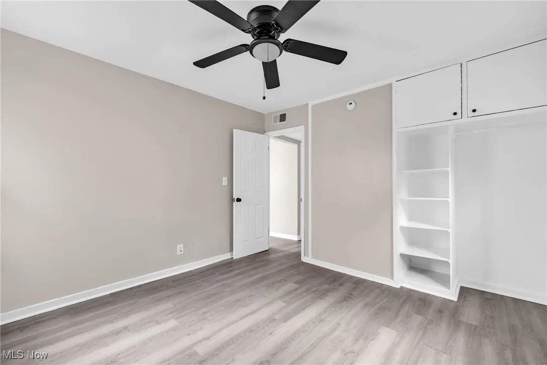 Unfurnished bedroom with light wood-style floors and a ceiling fan