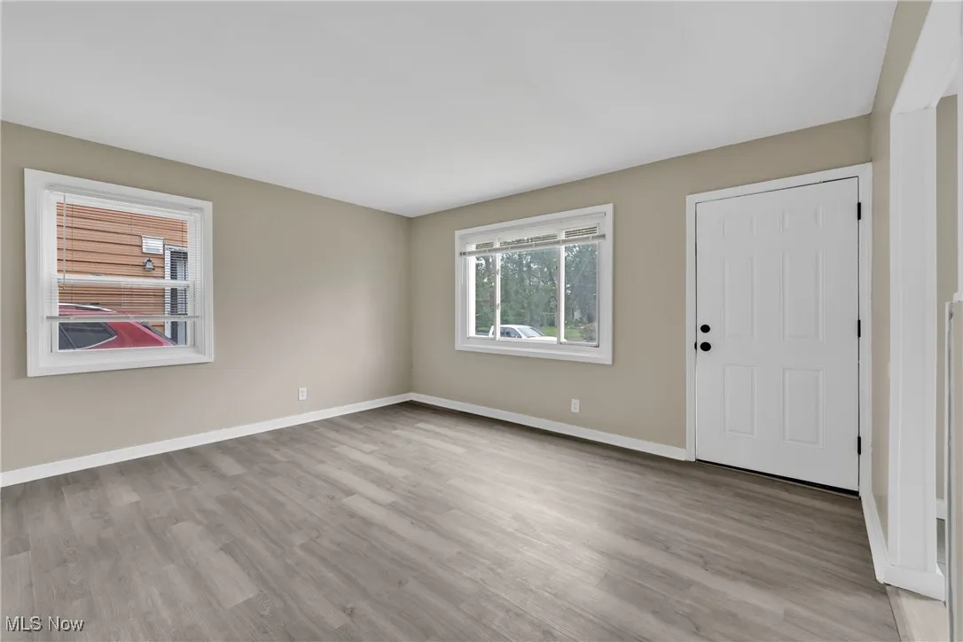 Foyer entrance featuring wood finished floors and baseboards