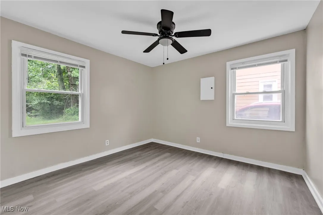 Spare room featuring wood finished floors and a ceiling fan