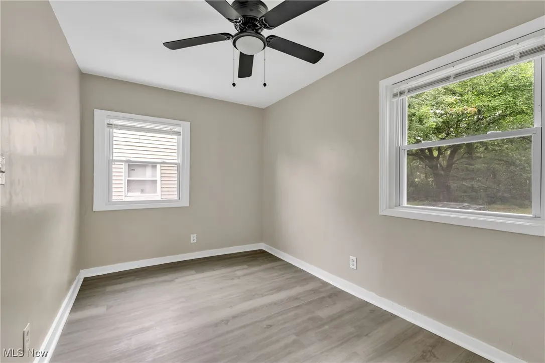 Spare room featuring wood finished floors and a ceiling fan