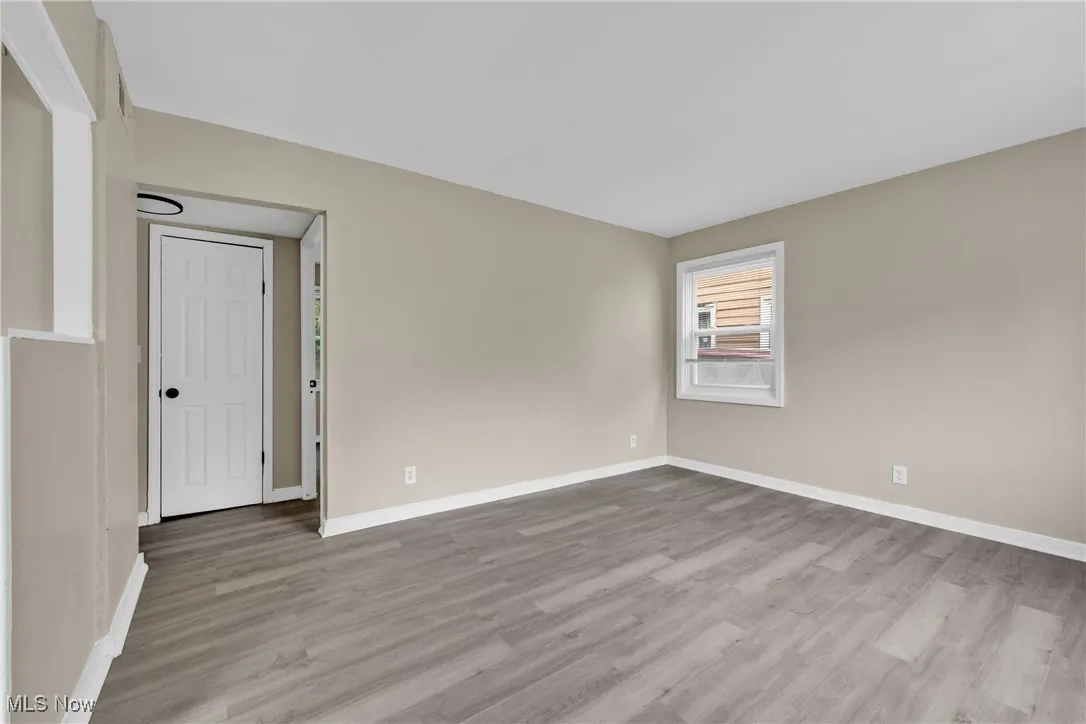 Spare room with wood finished floors and baseboards