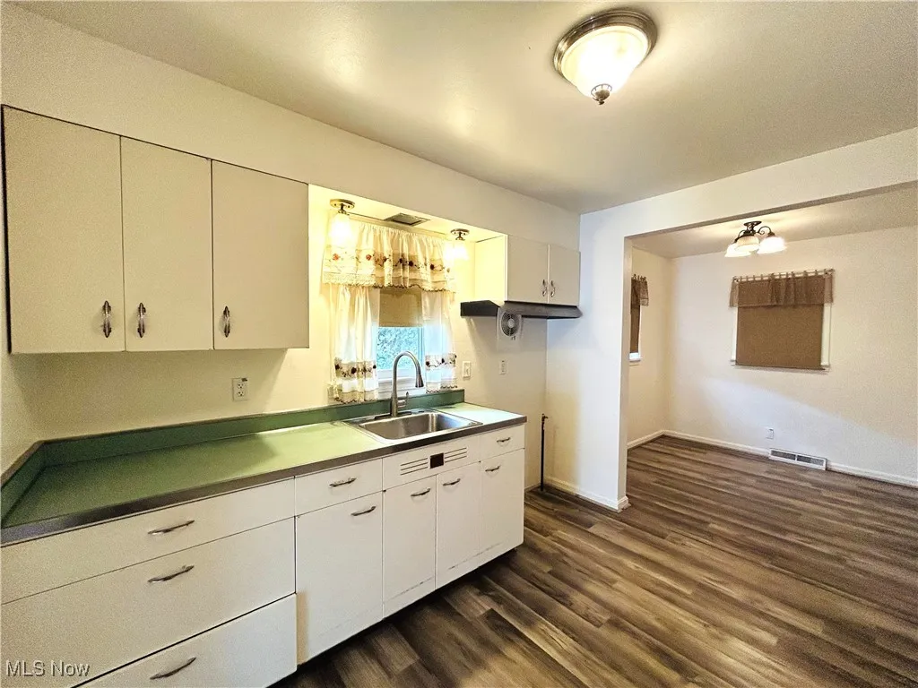 Kitchen with sink, and white cabinetry
